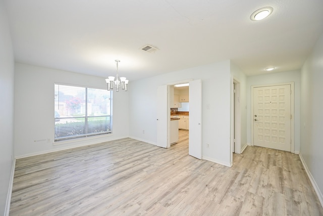 7735 Quail Meadow Dr, Houston, TX 77071 - empty room featuring a chandelier and light wood finished floors