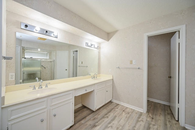 7735 Quail Meadow Dr, Houston, TX 77071 - full bathroom featuring double vanity, wood finished floors, and a shower with door