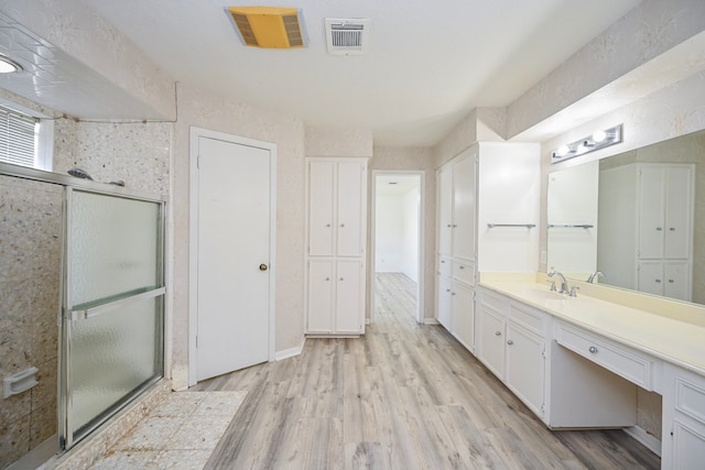 7735 Quail Meadow Dr, Houston, TX 77071 - bathroom featuring vanity, a stall shower, and wood finished floors
