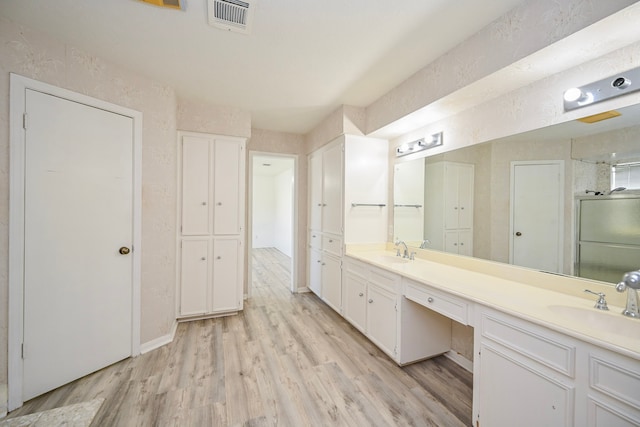 7735 Quail Meadow Dr, Houston, TX 77071 - full bath featuring double vanity, wood finished floors, a shower stall, and a closet