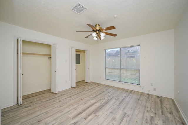 7735 Quail Meadow Dr, Houston, TX 77071 - unfurnished bedroom with light wood-style flooring, electric panel, and a ceiling fan