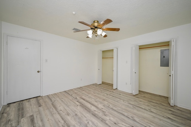 7735 Quail Meadow Dr, Houston, TX 77071 - unfurnished bedroom with two closets, electric panel, light wood-style flooring, and ceiling fan