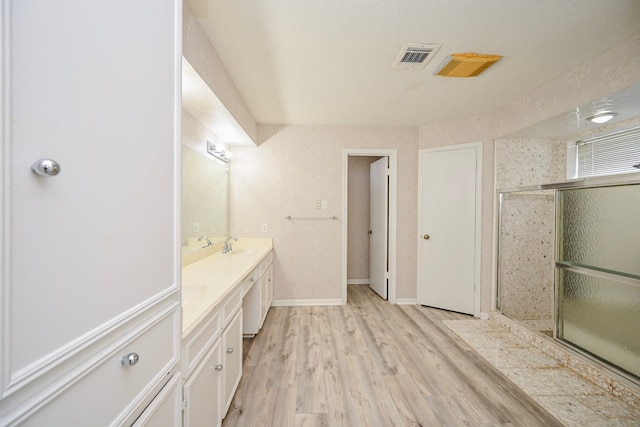 7735 Quail Meadow Dr, Houston, TX 77071 - bathroom featuring double vanity, wood finished floors, and a shower with shower door