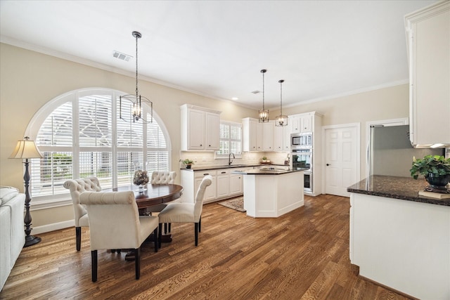 51 Dartmoor Ct, Sugar Land, TX 77479 - dining room with crown molding, dark wood-style flooring, a chandelier, and baseboards