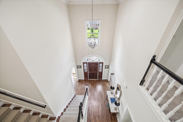 51 Dartmoor Ct, Sugar Land, TX 77479 - entrance foyer featuring a chandelier, a high ceiling, stairs, wood finished floors, and baseboards