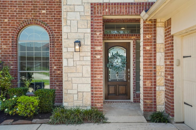 view of exterior entry featuring brick siding