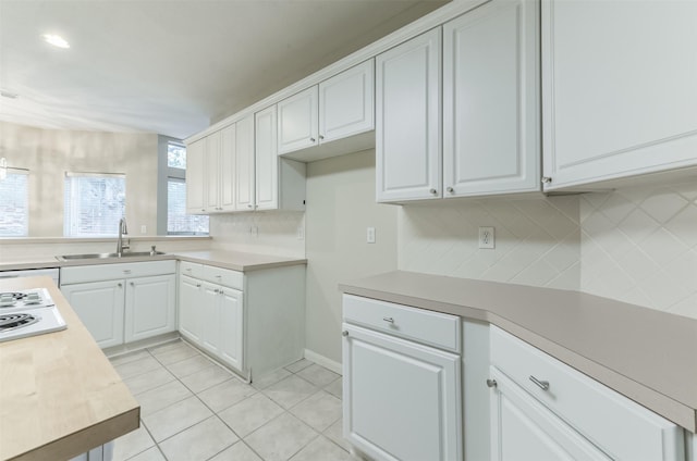 12950 Quail Park Dr, Cypress, TX 77429 - kitchen with a sink, decorative backsplash, light countertops, and light tile patterned flooring