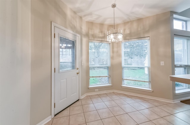 12950 Quail Park Dr, Cypress, TX 77429 - doorway with a chandelier, light tile patterned floors, and baseboards