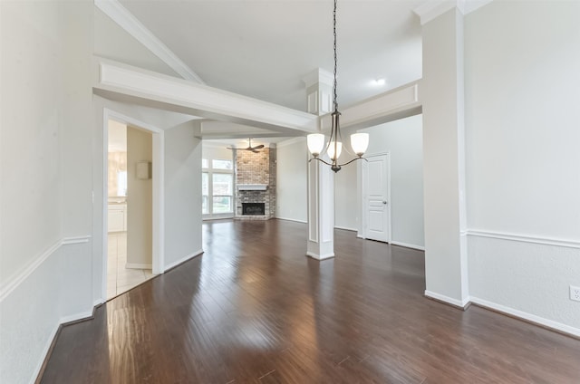 12950 Quail Park Dr, Cypress, TX 77429 - unfurnished dining area featuring dark wood finished floors, a chandelier, a large fireplace, and baseboards