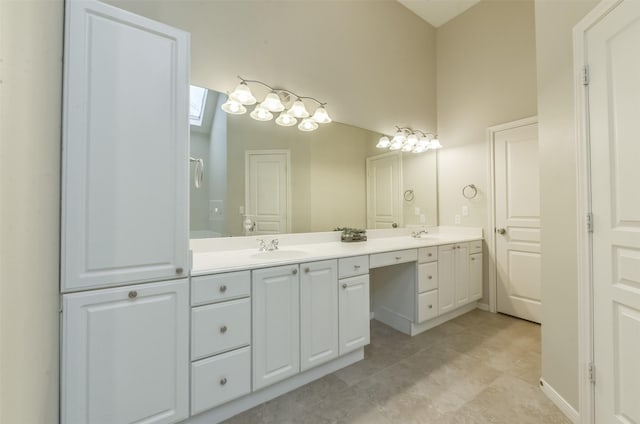 12950 Quail Park Dr, Cypress, TX 77429 - full bath with double vanity, tile patterned flooring, and a skylight
