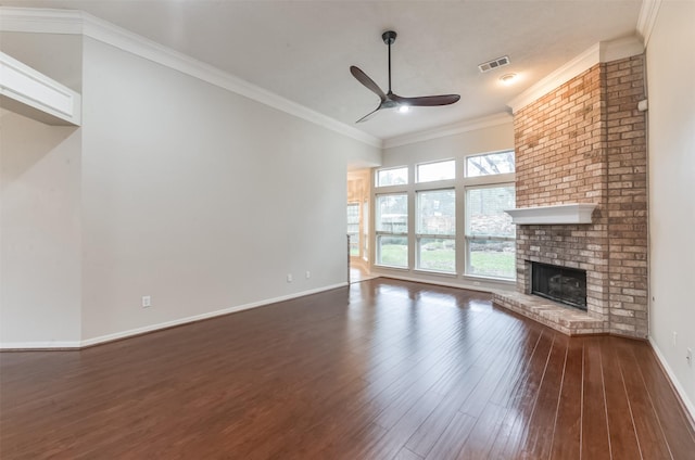 12950 Quail Park Dr, Cypress, TX 77429 - unfurnished living room featuring a ceiling fan, dark wood-style floors, ornamental molding, a brick fireplace, and baseboards