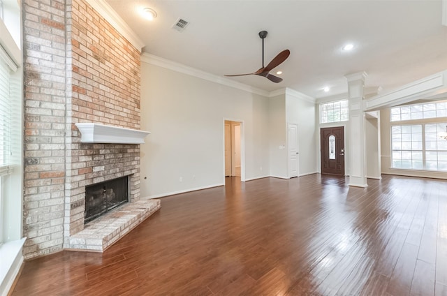 12950 Quail Park Dr, Cypress, TX 77429 - unfurnished living room featuring ceiling fan, a fireplace, crown molding, dark wood-style flooring, and baseboards
