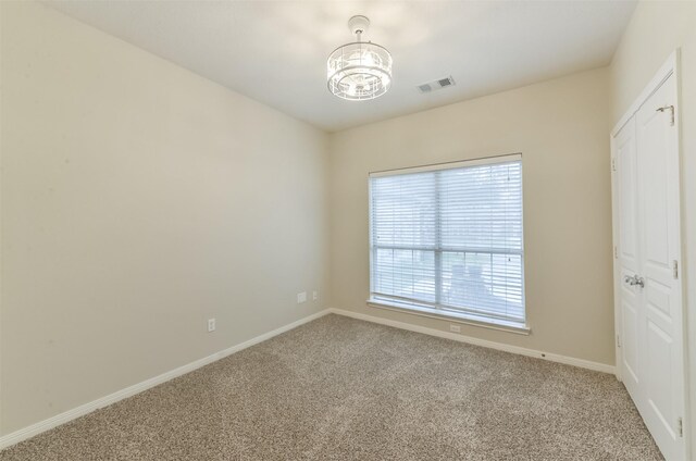 12950 Quail Park Dr, Cypress, TX 77429 - carpeted spare room featuring a chandelier and baseboards