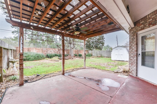 12950 Quail Park Dr, Cypress, TX 77429 - view of patio / terrace featuring a ceiling fan, a storage unit, and an outbuilding