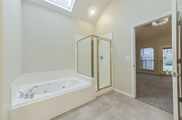 12950 Quail Park Dr, Cypress, TX 77429 - bathroom with a skylight, a shower stall, a jetted tub, tile patterned floors, and high vaulted ceiling