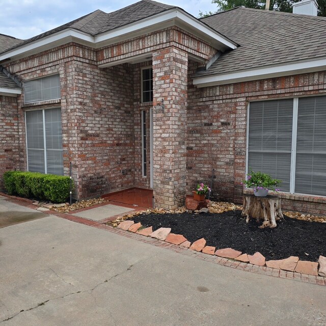 12950 Quail Park Dr, Cypress, TX 77429 - doorway to property featuring brick siding and roof with shingles