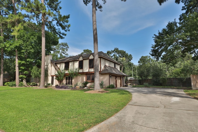 12923 Hunterfield Dr, Cypress, TX 77429 - tudor-style house with driveway, stucco siding, and a garage