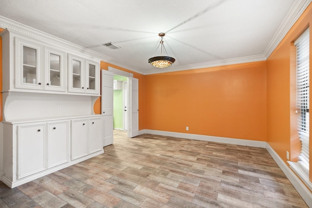 12923 Hunterfield Dr, Cypress, TX 77429 - unfurnished dining area featuring ornamental molding, light wood-type flooring, and baseboards