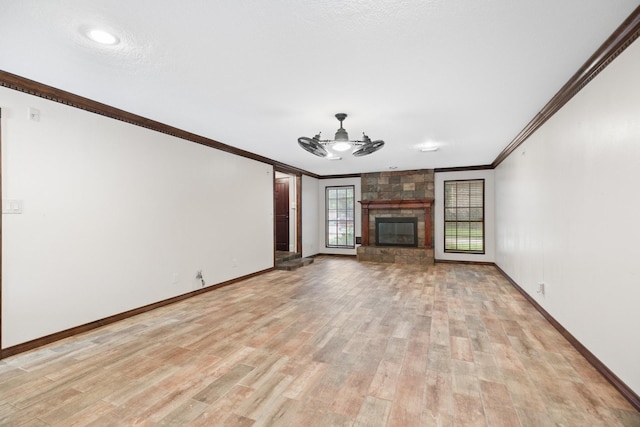 12923 Hunterfield Dr, Cypress, TX 77429 - unfurnished living room featuring ornamental molding, light wood-style flooring, baseboards, a fireplace, and ceiling fan