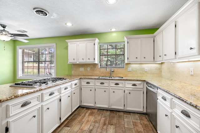 12923 Hunterfield Dr, Cypress, TX 77429 - kitchen with a sink, appliances with stainless steel finishes, white cabinetry, wood finished floors, and ceiling fan