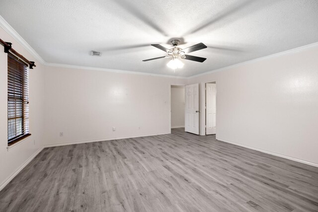 12923 Hunterfield Dr, Cypress, TX 77429 - spare room with wood finished floors, a ceiling fan, crown molding, baseboards, and a textured ceiling