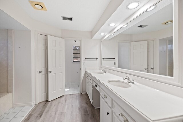 12923 Hunterfield Dr, Cypress, TX 77429 - full bath with double vanity, wood finished floors, recessed lighting, and baseboards