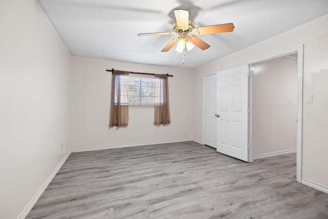 12923 Hunterfield Dr, Cypress, TX 77429 - unfurnished bedroom with wood finished floors, baseboards, a closet, and ceiling fan