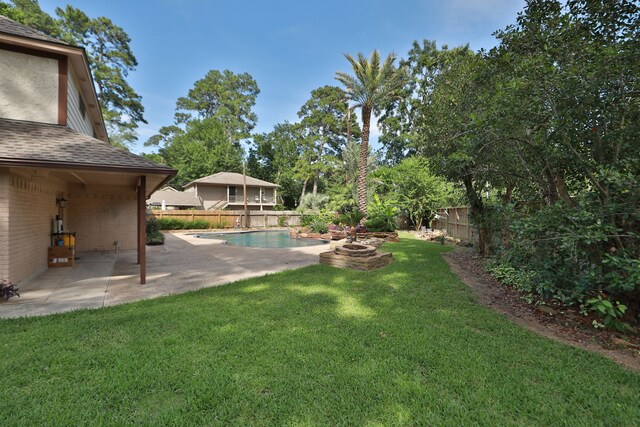 12923 Hunterfield Dr, Cypress, TX 77429 - view of yard featuring a patio area and an outdoor fire pit
