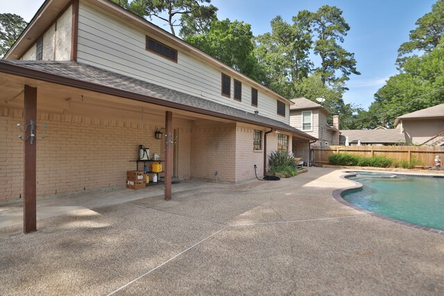 12923 Hunterfield Dr, Cypress, TX 77429 - back of property with fence, a patio, brick siding, and roof with shingles