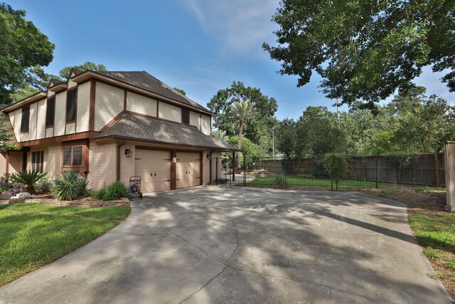 12923 Hunterfield Dr, Cypress, TX 77429 - view of property exterior featuring brick siding, driveway, and a garage