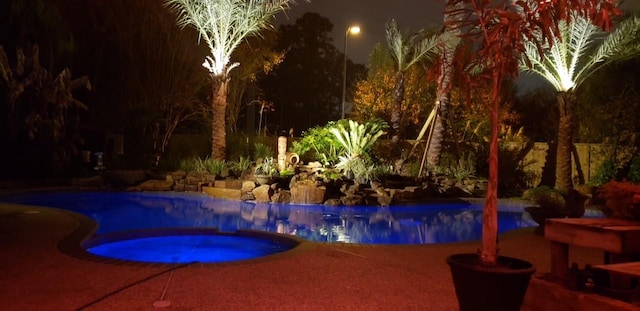 12923 Hunterfield Dr, Cypress, TX 77429 - pool at night with an in-ground hot tub and an outdoor pool