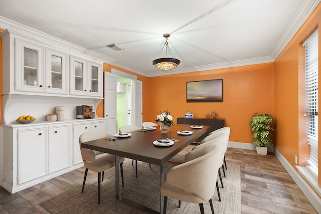 12923 Hunterfield Dr, Cypress, TX 77429 - dining room with light wood-type flooring, crown molding, and baseboards