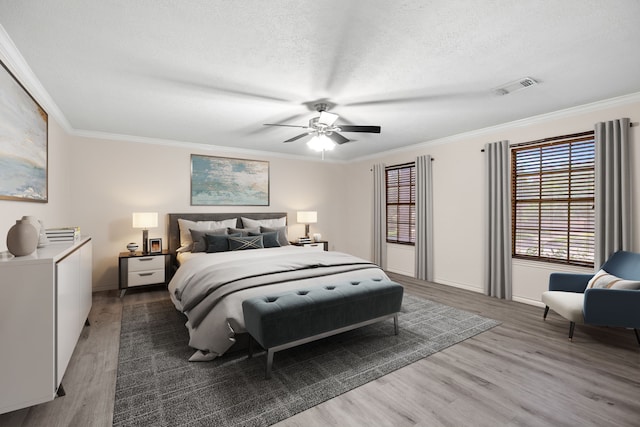 12923 Hunterfield Dr, Cypress, TX 77429 - bedroom featuring wood finished floors, ornamental molding, a textured ceiling, a ceiling fan, and baseboards