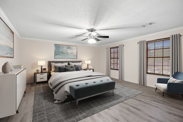 12923 Hunterfield Dr, Cypress, TX 77429 - bedroom with wood finished floors, crown molding, a textured ceiling, baseboards, and a ceiling fan