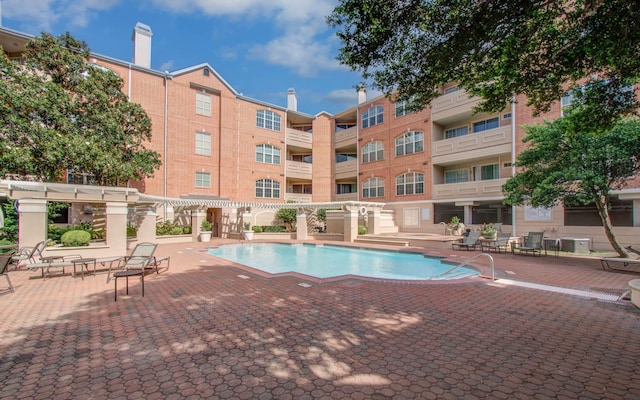 2111 Welch St Unit A110, Houston, TX 77019 - community pool with a pergola, a patio, and central air condition unit