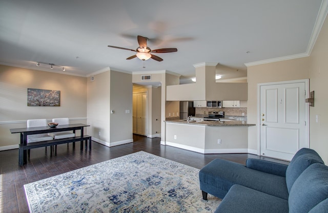 2111 Welch St Unit A110, Houston, TX 77019 - living room with a ceiling fan, dark wood-type flooring, baseboards, ornamental molding, and rail lighting