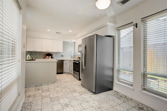 6202 Arcadian Shores Dr, Houston, TX 77084 - kitchen featuring appliances with stainless steel finishes, plenty of natural light, light countertops, and a ceiling fan
