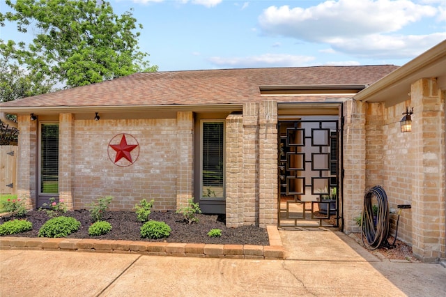 6202 Arcadian Shores Dr, Houston, TX 77084 - view of exterior entry with brick siding and roof with shingles