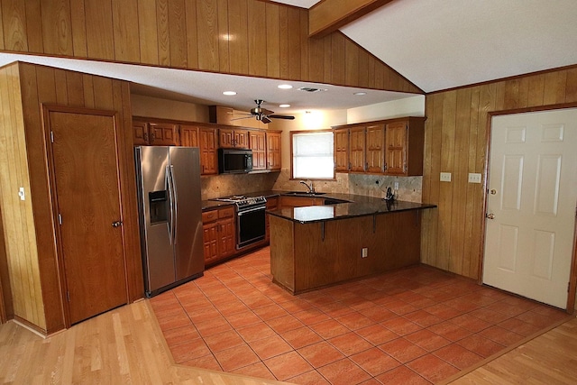 606 County Road 1947, Yantis, TX 75497 - kitchen with stainless steel fridge, black microwave, a peninsula, dark countertops, and a sink