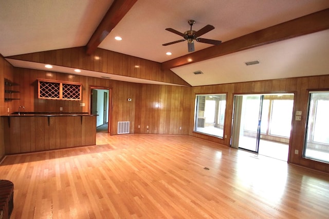 606 County Road 1947, Yantis, TX 75497 - unfurnished living room featuring wood walls, light wood-type flooring, a ceiling fan, bar, and recessed lighting