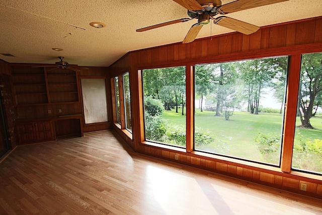 606 County Road 1947, Yantis, TX 75497 - unfurnished sunroom featuring wood walls, healthy amount of natural light, wood finished floors, and vaulted ceiling