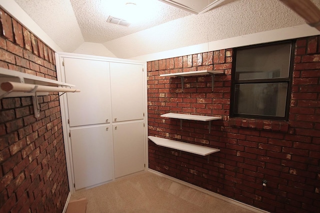 606 County Road 1947, Yantis, TX 75497 - bar with carpet, a textured ceiling, lofted ceiling, and brick wall