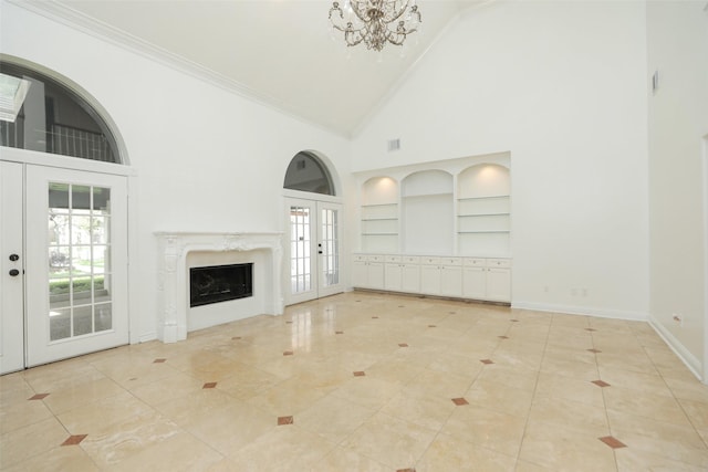 4603 Joyce Blvd, Houston, TX 77084 - unfurnished living room featuring high vaulted ceiling, built in shelves, french doors, a chandelier, and baseboards