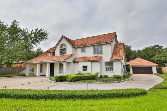 4603 Joyce Blvd, Houston, TX 77084 - mediterranean / spanish home with stucco siding, a tile roof, fence, a porch, and driveway