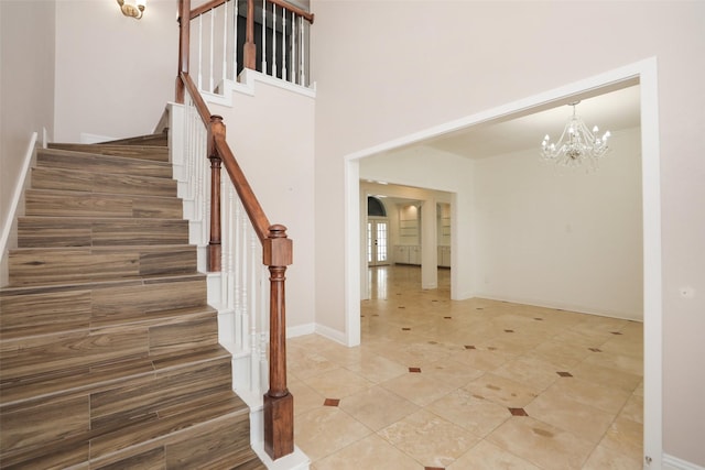 4603 Joyce Blvd, Houston, TX 77084 - stairway with a chandelier, tile patterned floors, and baseboards