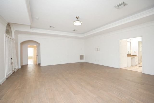 4603 Joyce Blvd, Houston, TX 77084 - unfurnished room with arched walkways, ornamental molding, light wood-type flooring, and a tray ceiling