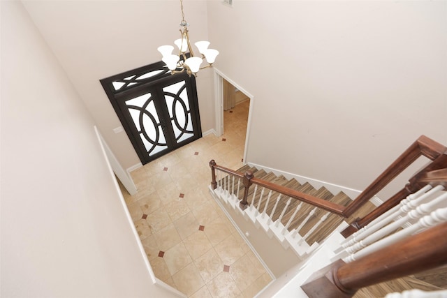 4603 Joyce Blvd, Houston, TX 77084 - staircase with a chandelier, baseboards, tile patterned floors, and a high ceiling