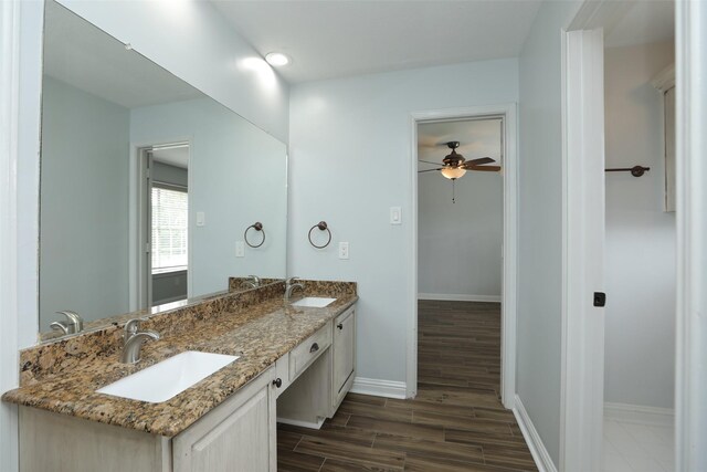 4603 Joyce Blvd, Houston, TX 77084 - full bathroom with wood finished floors, baseboards, ceiling fan, and double vanity