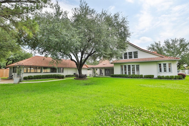 4603 Joyce Blvd, Houston, TX 77084 - back of house featuring a tile roof, stucco siding, and a yard