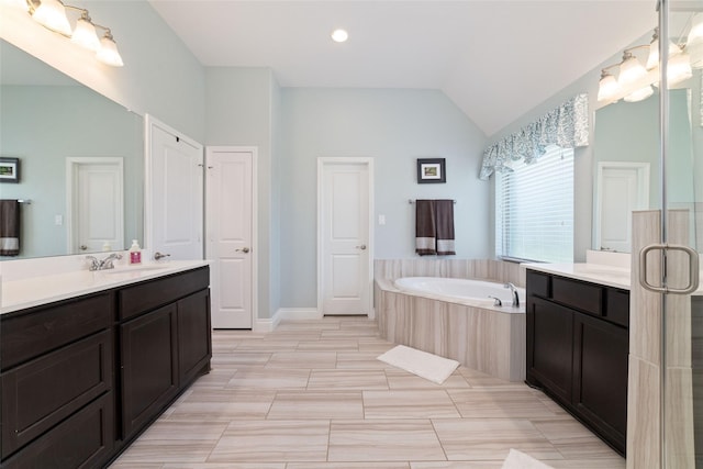 bathroom with vaulted ceiling, a garden tub, vanity, recessed lighting, and baseboards